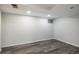 Unfurnished basement featuring wood-style flooring, a window and recessed lighting at 9345 W Iowa Pl, Lakewood, CO 80232