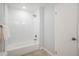 Clean bathroom featuring a tiled shower and tub combination with modern shower head at 9345 W Iowa Pl, Lakewood, CO 80232