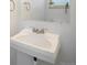 Bathroom features a white pedestal sink, mirror, and a plant on the shelf at 9345 W Iowa Pl, Lakewood, CO 80232