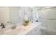 Bright bathroom features double sinks with quartz countertops and a shower with glass doors at 9345 W Iowa Pl, Lakewood, CO 80232