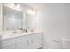Bright bathroom featuring double sink vanity with modern fixtures and large mirrors at 9345 W Iowa Pl, Lakewood, CO 80232