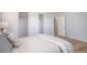 Bedroom features hardwood floors, neutral walls, closet, and beautifully decorated bed at 9345 W Iowa Pl, Lakewood, CO 80232