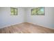 Bedroom features hardwood floors, neutral walls, two windows, and an air conditioning vent at 9345 W Iowa Pl, Lakewood, CO 80232