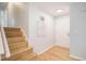 Welcoming entryway with hardwood floors, staircase, and bright natural light at 9345 W Iowa Pl, Lakewood, CO 80232