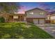 Charming two-story home featuring brick and siding, a covered porch, and a well-manicured lawn at 9345 W Iowa Pl, Lakewood, CO 80232