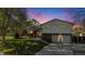 Inviting two-story home with manicured lawn, brick details, and attached garage under a vibrant sky at 9345 W Iowa Pl, Lakewood, CO 80232