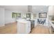 Bright kitchen features quartz countertops, stainless appliances, open floorplan, and dining area at 9345 W Iowa Pl, Lakewood, CO 80232
