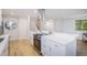Bright kitchen boasts white cabinets, quartz countertops, stainless appliances, and open floorplan at 9345 W Iowa Pl, Lakewood, CO 80232