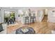 Open-concept living space with hardwood floors, a modern kitchen, and bright natural light at 9345 W Iowa Pl, Lakewood, CO 80232