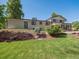 Backyard featuring mature trees, brick home, and lush green lawn at 11569 W 27Th Ave, Lakewood, CO 80215