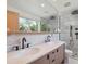 Modern bathroom features double vanity, tile shower, and natural light at 11569 W 27Th Ave, Lakewood, CO 80215