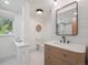 Modern bathroom featuring a stone countertop, sleek mirror, and outside view at 11569 W 27Th Ave, Lakewood, CO 80215