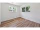 Sunlit room with natural wood floors and large windows showcasing outdoor views at 11569 W 27Th Ave, Lakewood, CO 80215