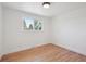 Simple room with natural light, hardwood floors, and a neutral color scheme at 11569 W 27Th Ave, Lakewood, CO 80215