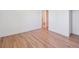 Spacious room with wooden floors, light colored walls, and a glimpse into the hall at 11569 W 27Th Ave, Lakewood, CO 80215