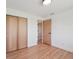 Bright bedroom with wooden closet doors and access to additional rooms at 11569 W 27Th Ave, Lakewood, CO 80215