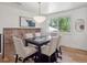 Bright dining room with modern chandelier and table for four overlooking an outdoor view at 11569 W 27Th Ave, Lakewood, CO 80215