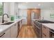 Spacious kitchen features stainless appliances, a large island, and sleek modern countertops at 11569 W 27Th Ave, Lakewood, CO 80215