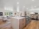 Open concept kitchen featuring a large island, stainless steel appliances, and wood floors at 11569 W 27Th Ave, Lakewood, CO 80215