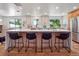 Modern kitchen island with seating, stylish countertops, and windows providing natural light at 11569 W 27Th Ave, Lakewood, CO 80215