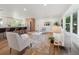 Comfortable living room with an open layout to the kitchen, featuring a plush rug and large windows at 11569 W 27Th Ave, Lakewood, CO 80215