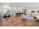 Bright, open-concept living room flowing into a modern kitchen with light wood floors at 11569 W 27Th Ave, Lakewood, CO 80215