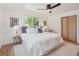 Cozy bedroom featuring a ceiling fan, window views, and closet space at 11569 W 27Th Ave, Lakewood, CO 80215