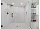 Modern glass enclosed shower with sleek fixtures and convenient storage shelves at 11569 W 27Th Ave, Lakewood, CO 80215