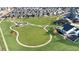Panoramic aerial view of a community featuring lush green spaces, playgrounds, and well-manicured homes at 17908 E 54Th Ave, Denver, CO 80249