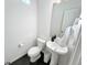 Powder room featuring a pedestal sink and modern fixtures, creating a clean and functional space at 17908 E 54Th Ave, Denver, CO 80249