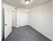 Neutral bedroom featuring carpet flooring, a double closet, and a single door at 17908 E 54Th Ave, Denver, CO 80249