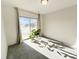Bright living room featuring a sliding glass door to the outside with natural light and neutral carpet at 17908 E 54Th Ave, Denver, CO 80249