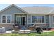 Charming patio with wicker furniture and a beautifully landscaped backyard at 7824 S Zante Ct, Aurora, CO 80016