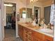 Bathroom with double sinks, framed mirrors, and a large walk-in closet at 7824 S Zante Ct, Aurora, CO 80016