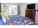 Bright bedroom with a bed and window overlooking a fenced green area at 7824 S Zante Ct, Aurora, CO 80016
