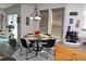 Sunlit dining area with a round table and seating for four, tile floors, and Keurig coffee maker at 7824 S Zante Ct, Aurora, CO 80016