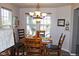 Charming dining room with wood floors, a modern chandelier, and a serene atmosphere for Gathering meals at 7824 S Zante Ct, Aurora, CO 80016