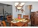 Well-lit dining room featuring a wooden table, comfortable seating, and an adjacent living area at 7824 S Zante Ct, Aurora, CO 80016