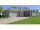 Charming home featuring a spacious driveway, a well-manicured lawn, and a welcoming two-car garage at 7824 S Zante Ct, Aurora, CO 80016