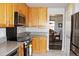 Well-lit kitchen features modern appliances, wooden cabinetry, and granite countertops at 7824 S Zante Ct, Aurora, CO 80016