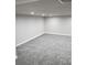 An open basement space featuring new carpet and neutral color walls and trim at 5677 S Lowell Blvd, Littleton, CO 80123
