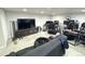 Finished basement features a large television and multiple desks at 5677 S Lowell Blvd, Littleton, CO 80123