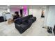 Finished basement area with carpeted floors and a black sofa at 5677 S Lowell Blvd, Littleton, CO 80123