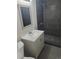 A view of the sink and shower in a nicely remodeled bathroom with gray tile at 5677 S Lowell Blvd, Littleton, CO 80123