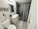 Modern bathroom with a shower, vanity, and gray tile at 5677 S Lowell Blvd, Littleton, CO 80123