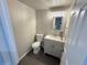 Bathroom with modern vanity, mirror, lighting, toilet, and neutral color scheme at 5677 S Lowell Blvd, Littleton, CO 80123