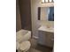 Nicely remodeled bathroom featuring gray tiled floor, shower, mirror, and a vanity at 5677 S Lowell Blvd, Littleton, CO 80123
