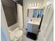 Bright bathroom with a gray vanity, dual sinks, lots of light and tiled backsplash at 5677 S Lowell Blvd, Littleton, CO 80123