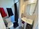 Cozy bathroom with pedestal sink, toilet, tub and shower with black fixtures at 5677 S Lowell Blvd, Littleton, CO 80123