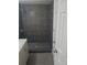 Modern bathroom featuring a stylish shower with gray tiling and a sleek vanity at 5677 S Lowell Blvd, Littleton, CO 80123